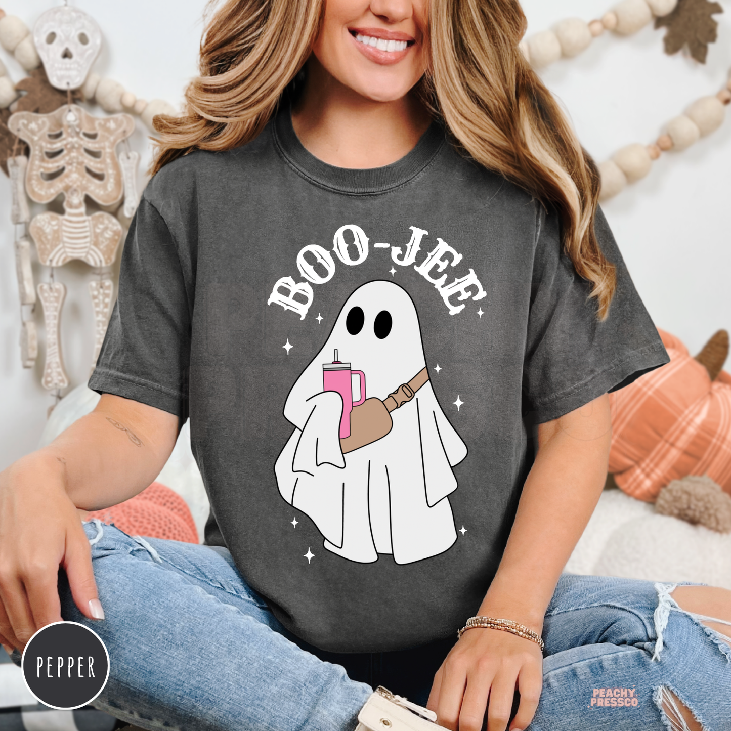 Woman wearing a pepper Comfort Colors Boo-Jee ghost Halloween t-shirt with trendy ghost graphic.