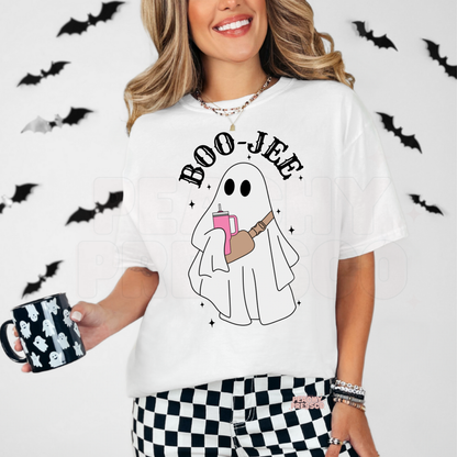 Woman wearing a white Boo-Jee ghost Halloween t-shirt with cute ghost graphic and bats in the background.
