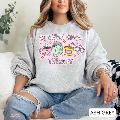 Ash Grey crewneck sweatshirt with Bookish Girly Therapy design featuring coffee, book, candle, and reading glasses.