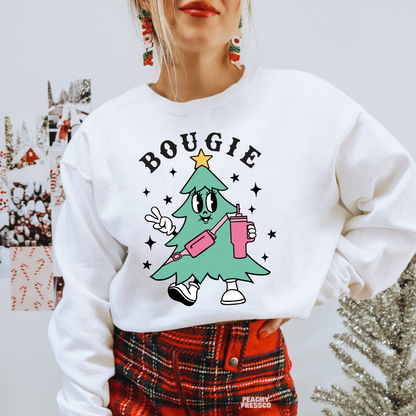Woman wearing a white crewneck sweatshirt with a retro Bougie Christmas tree graphic paired with a red plaid skirt.