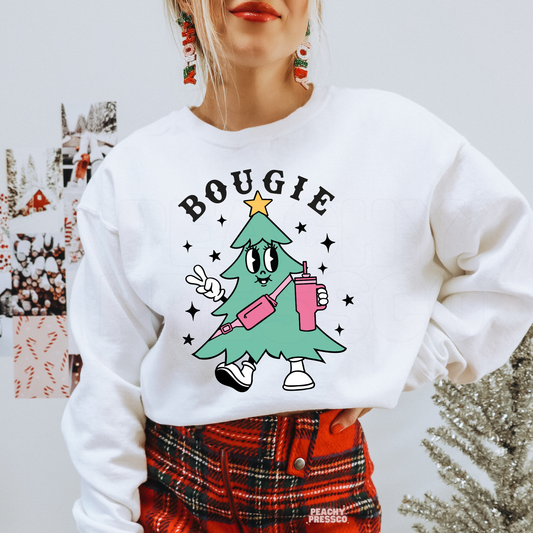 Woman wearing a white crewneck sweatshirt with a retro Bougie Christmas tree graphic paired with a red plaid skirt.