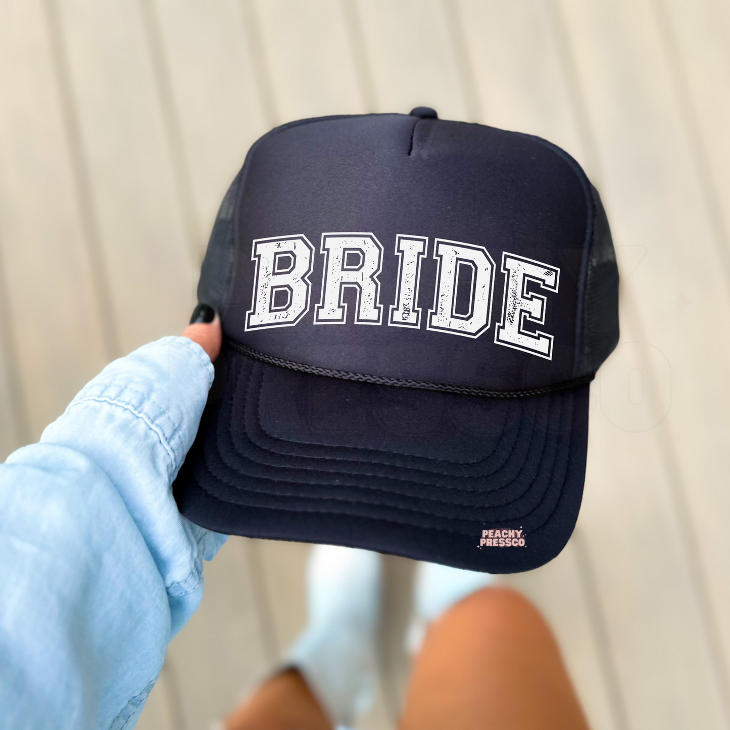 Black foam trucker hat with distressed "BRIDE" varsity lettering, stylish bridal accessory for bachelorette parties, bridal showers, and wedding celebrations.