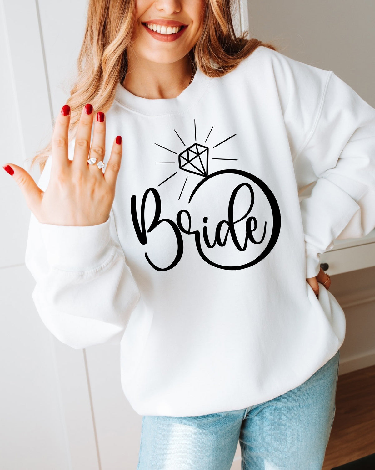 White sweatshirt featuring a bold black "Bride" engagement ring design, perfect for bridal showers, getting-ready photos, engagement gifts, and wedding celebrations.