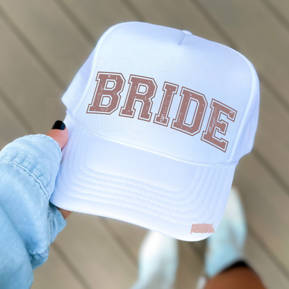 White foam trucker hat featuring "BRIDE" in distressed collegiate lettering, perfect for bridal showers, bachelorette parties, wedding weekends, and honeymoon trips.