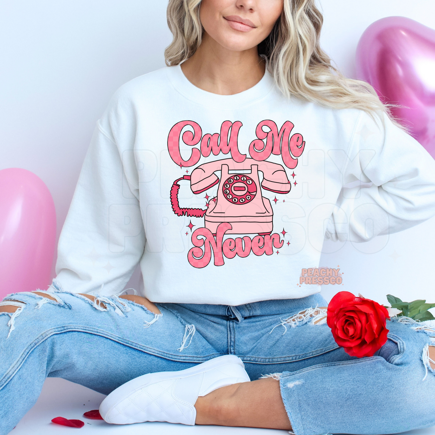 Funny Call Me Never graphic printed on a white crewneck sweatshirt featuring a retro pink rotary telephone with coquette-inspired Valentine's design.