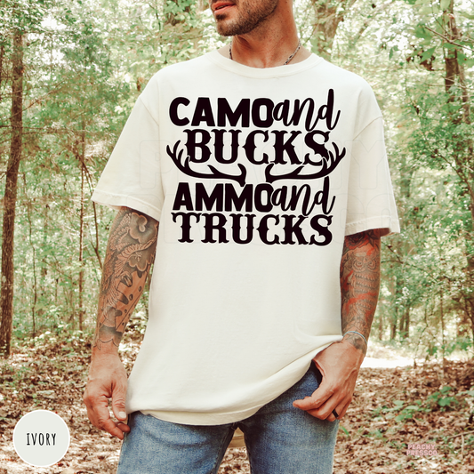 Ivory garment-dyed t-shirt featuring the bold "Camo and Bucks Ammo and Trucks" deer hunting design with antlers. Ideal gift for hunting dads, outdoorsmen, and truck lovers.