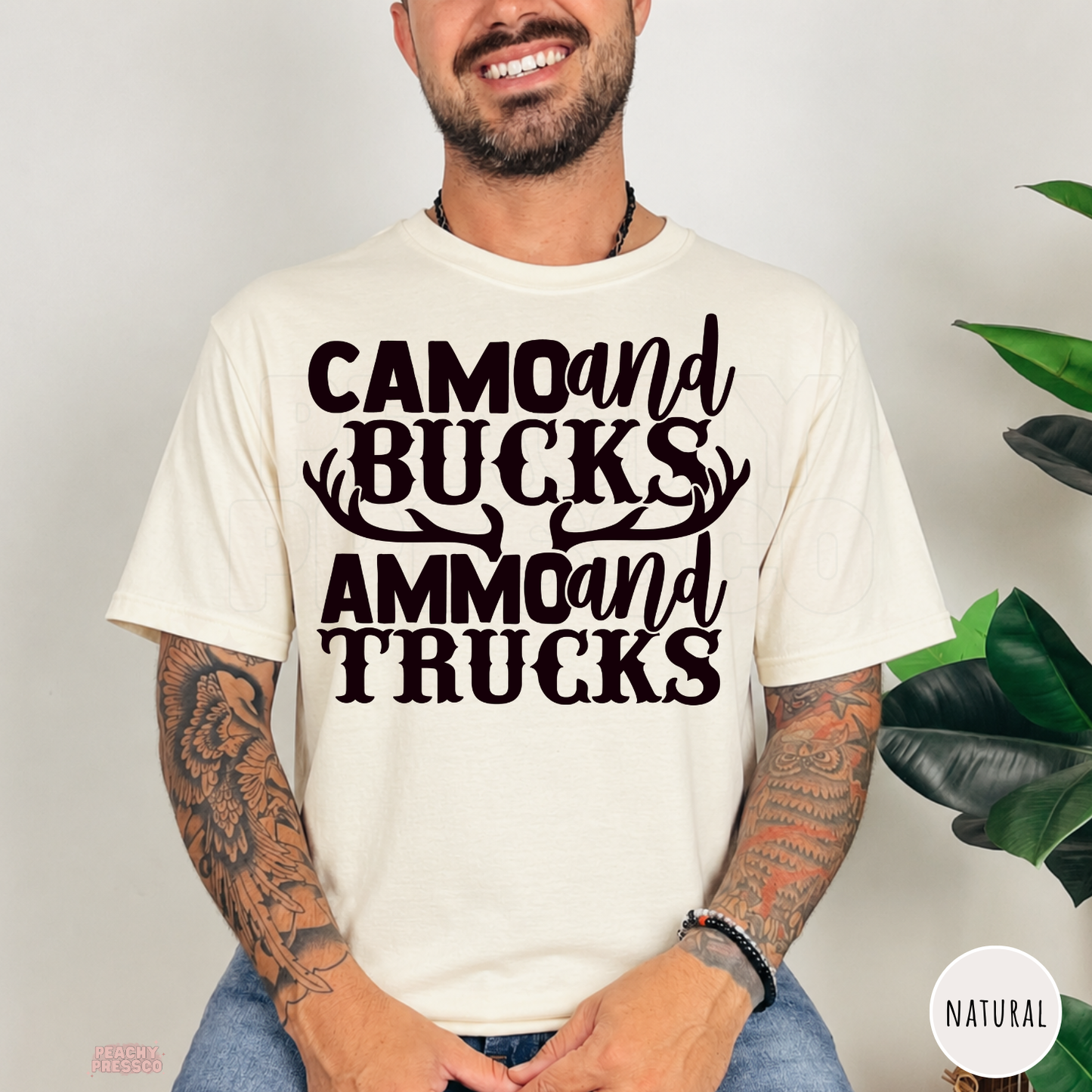 Natural t-shirt featuring the funny "Camo and Bucks Ammo and Trucks" hunting graphic with deer antlers. Perfect gift for deer hunters, outdoorsmen, country dads, and hunting enthusiasts.