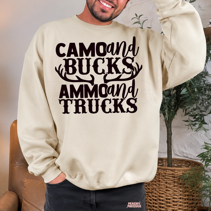Sand crewneck sweatshirt featuring the "Camo and Bucks Ammo and Trucks" hunting graphic with antlers. Cozy gift for deer hunters, outdoorsmen, and country dads.