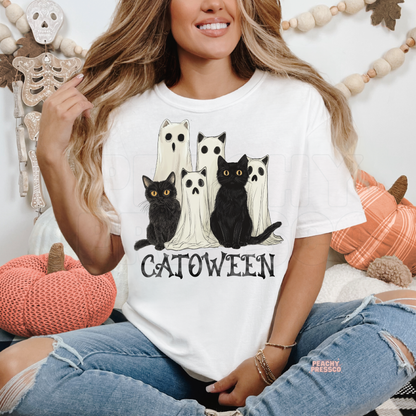 Woman wearing a white t-shirt featuring a Catoween black cat and ghost Halloween design, perfect for spooky season and cat lovers.