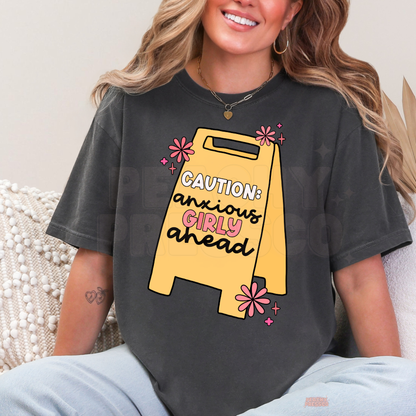 Pepper charcoal Caution Anxious Girly Ahead graphic t-shirt featuring a yellow caution sign, pink flowers and a funny relatable anxiety quote.