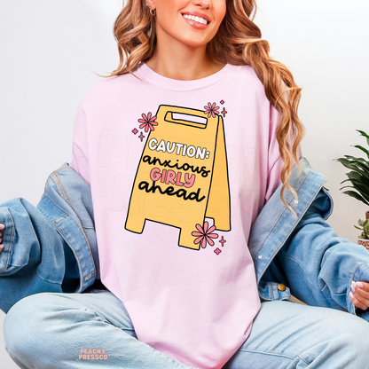 Light pink Caution Anxious Girly Ahead shirt featuring a yellow caution sign with adorable pink flowers and playful anxiety humor for overthinkers.