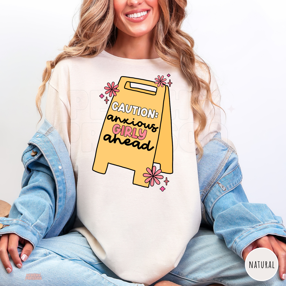 Natural Caution Anxious Girly Ahead shirt featuring a yellow warning sign with black and pink lettering, cute pink daisies and funny anxiety humor.