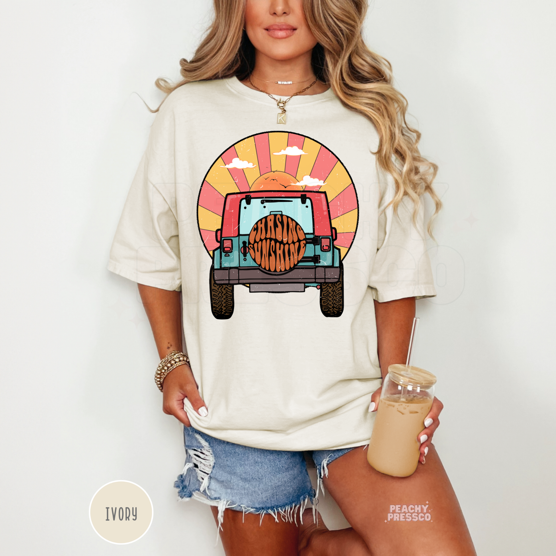 Ivory Comfort Colors unisex t-shirt featuring a retro off-road vehicle driving into the sunset with "Chasing Sunshine" on the spare tire. Soft garment-dyed tee with vintage coastal colors, perfect for beach lovers, summer adventures, camping, road trips, and relaxed everyday style.