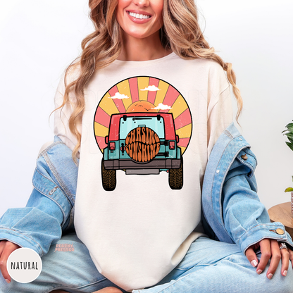Natural Gildan unisex t-shirt featuring a retro off-road vehicle driving toward a colorful sunset with "Chasing Sunshine" on the spare tire. Vintage-inspired beach graphic with warm sunset tones, perfect for summer, lake days, camping, road trips, and outdoor adventures.