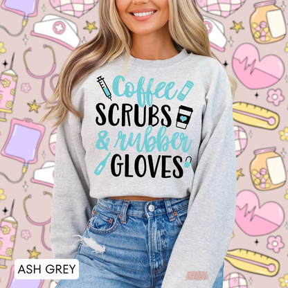 Woman wearing an ash grey Coffee Scrubs & Rubber Gloves sweatshirt with turquoise and black medical graphics against a nurse themed background.