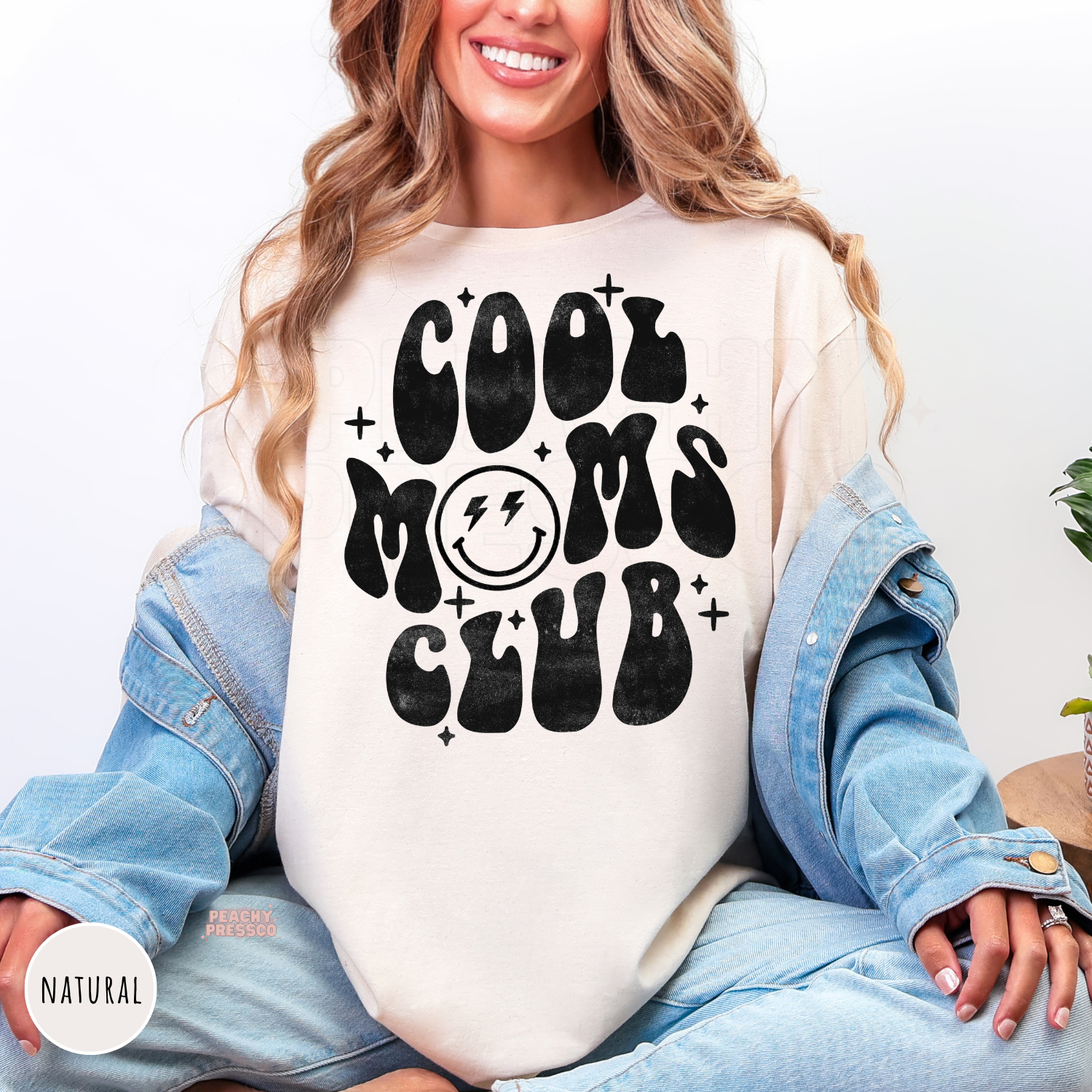 Natural shirt featuring the "Cool Moms Club" vintage smiley face graphic in bold retro lettering. Stylish mom sweatshirt for everyday wear.