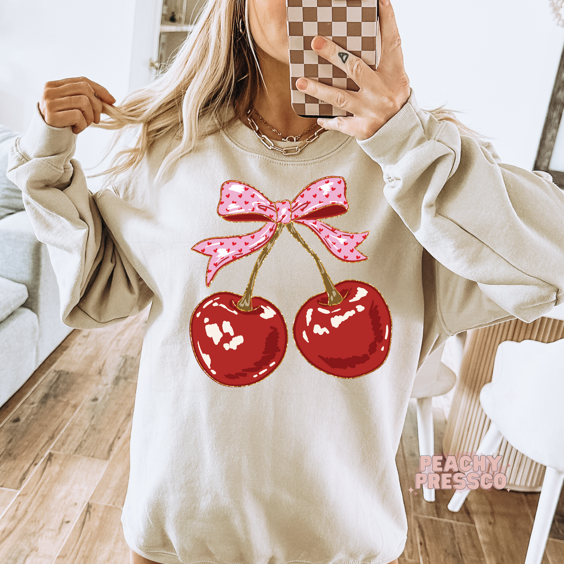 Sand crewneck sweatshirt featuring a pink bow and cherry graphic, cozy coquette aesthetic sweatshirt for women.