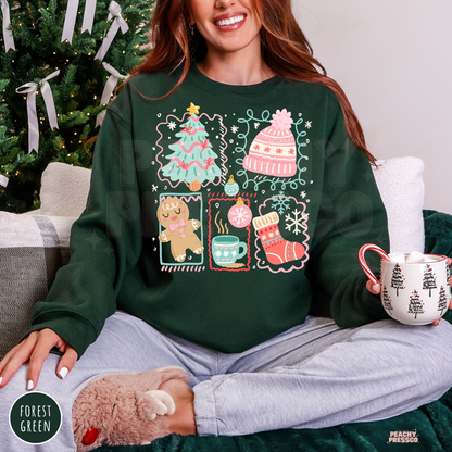 A woman wearing a forest green crewneck sweatshirt with a colorful Christmas-themed graphic print, sitting on a couch and holding a mug.