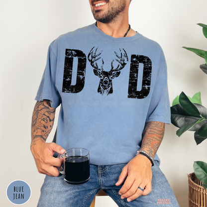 Blue Jean garment-dyed t-shirt featuring a distressed "DAD" design with a majestic buck deer head in the center. Perfect Father's Day gift for hunters, outdoorsmen, deer hunters, and wildlife lovers.