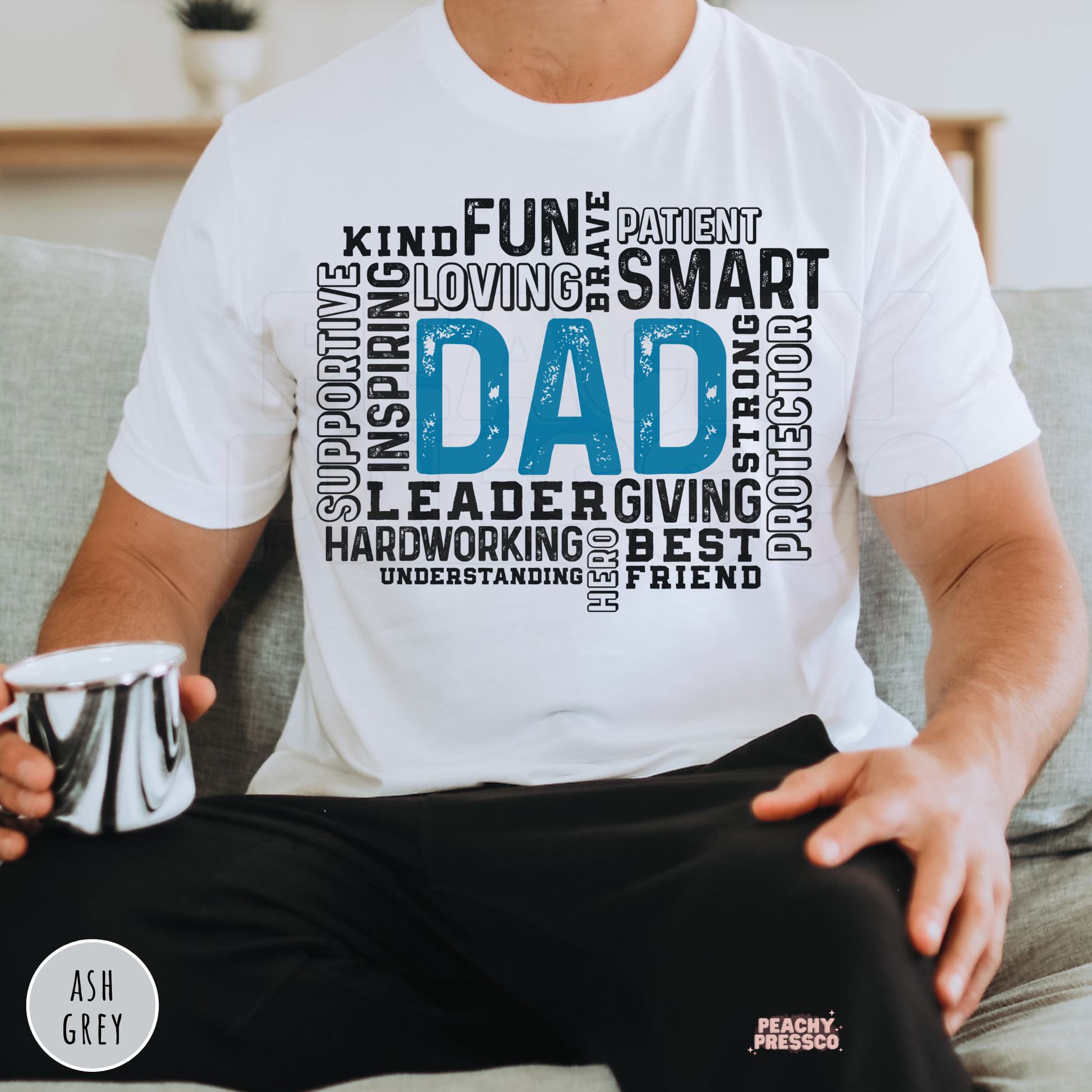 White unisex t-shirt featuring a distressed blue "Dad" typography word art design celebrating fathers with words like kind, inspiring, smart, brave, supportive, and best friend.