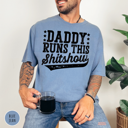 Blue Jean Comfort Colors t-shirt featuring the distressed Daddy Runs This Shitshow graphic in bold black lettering, a funny gift for dads.