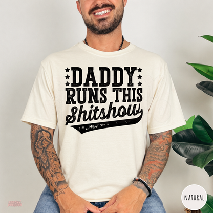 Natural t-shirt featuring the distressed Daddy Runs This Shitshow design in bold black lettering, a funny gift for dads.