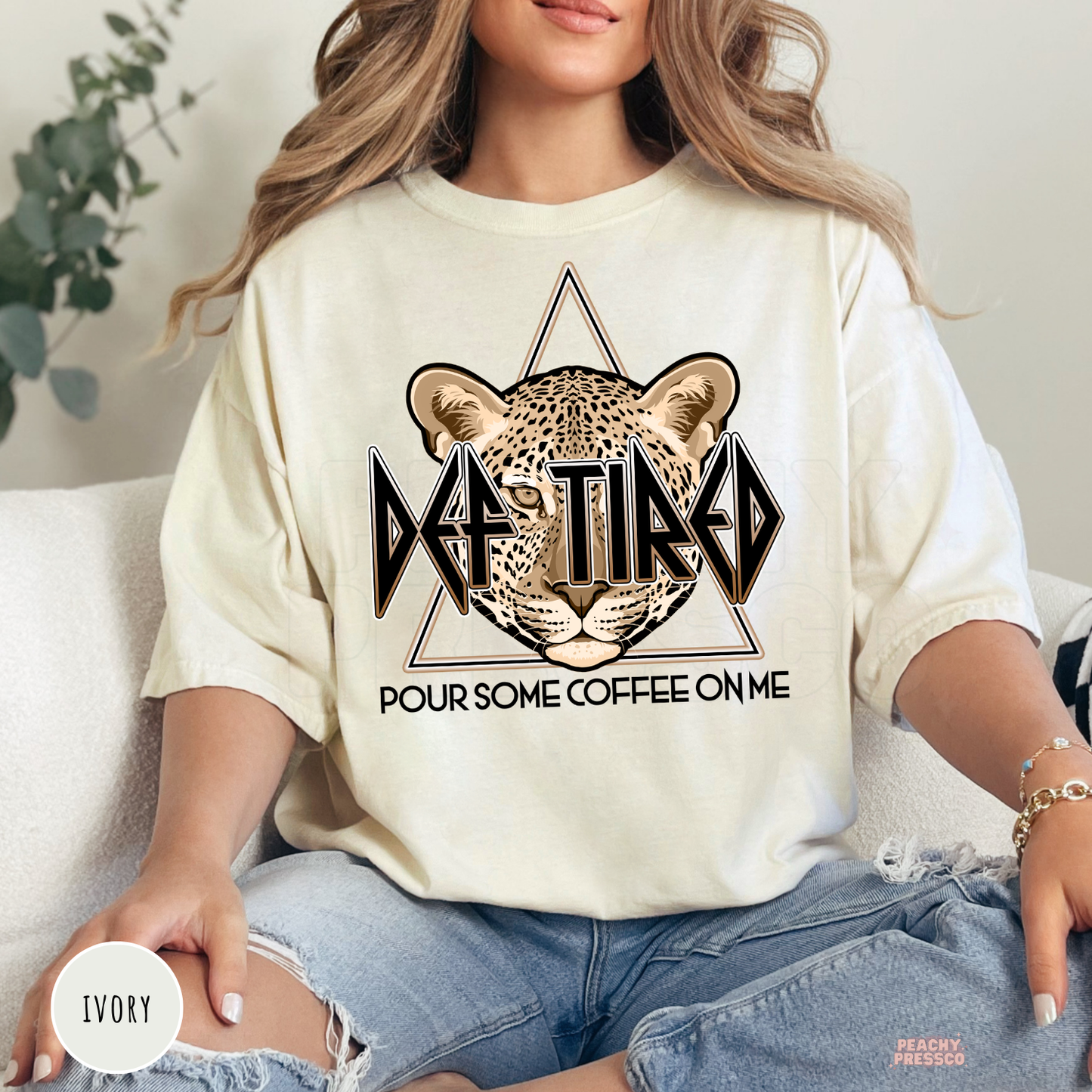 Ivory Def Tired Pour Some Coffee On Me graphic shirt with a leopard illustration and vintage coffee lover graphic.