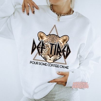 White crewneck sweatshirt featuring the Def Tired Pour Some Coffee On Me leopard graphic with a retro coffee-inspired design.