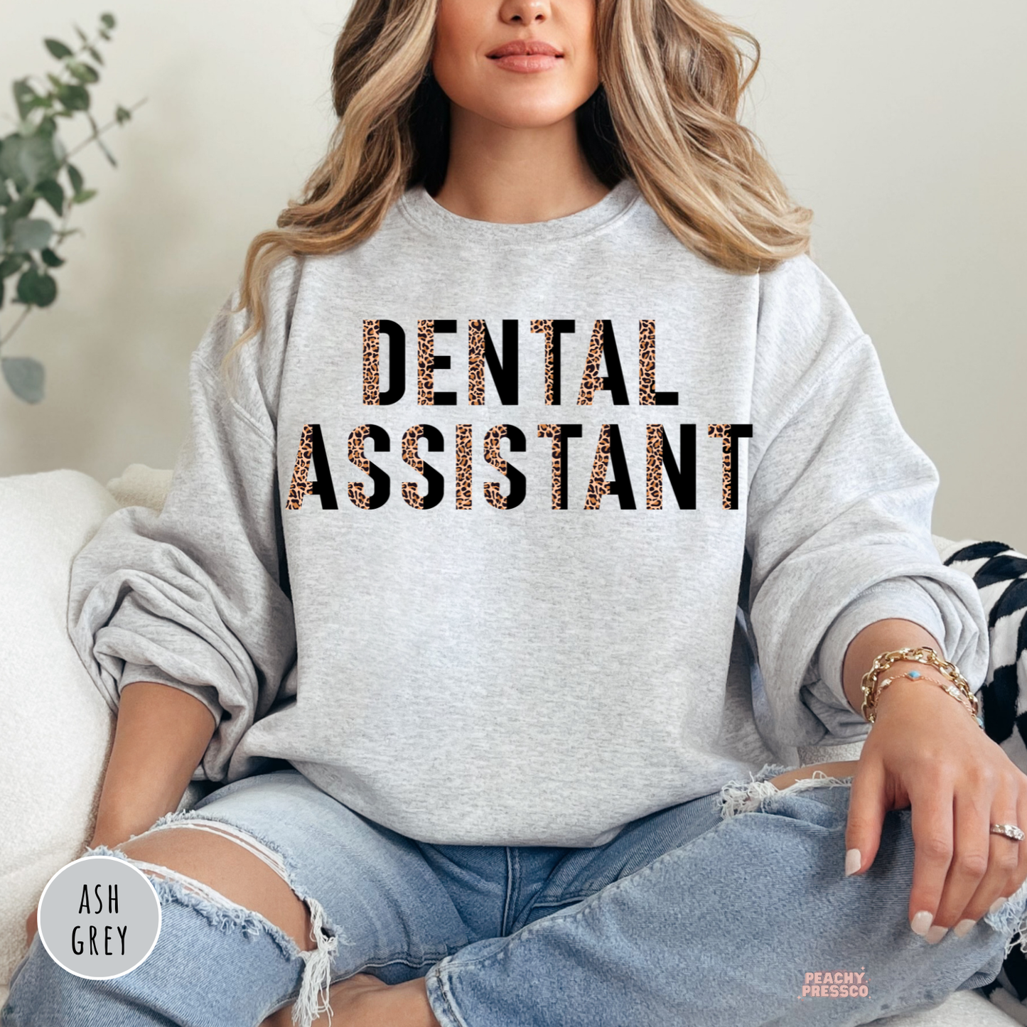 Ash grey crewneck sweatshirt featuring a modern leopard print Dental Assistant design, ideal for dental assistants, dental clinics, and healthcare professionals.