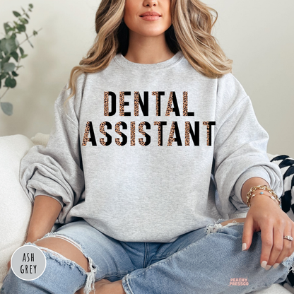 Ash grey crewneck sweatshirt featuring a modern leopard print Dental Assistant design, ideal for dental assistants, dental clinics, and healthcare professionals.