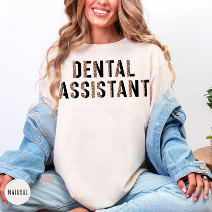 Natural shirt with a bold leopard print Dental Assistant graphic, a thoughtful gift for dental assistants, dentist office staff, and dental professionals.