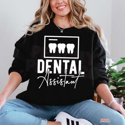 Woman wearing a black Dental Assistant crewneck sweatshirt with white tooth icons and lettering, a gift for dental assistants.