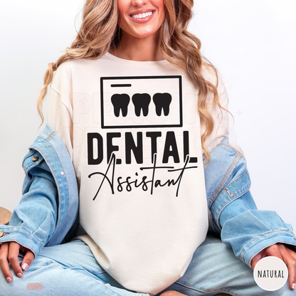 Woman modeling a natural Dental Assistant shirt with black tooth graphics and script lettering, a gift idea for dental assistants.