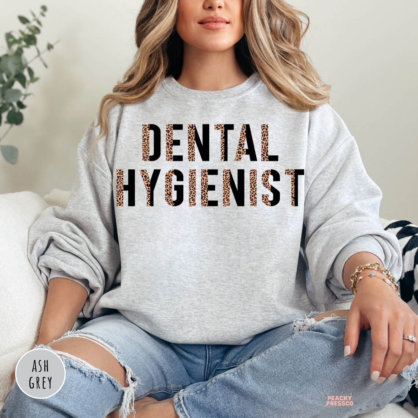 Ash grey crewneck sweatshirt with a modern leopard print Dental Hygienist graphic, a cozy gift for dental hygienists, dental clinics, and dentist office staff.