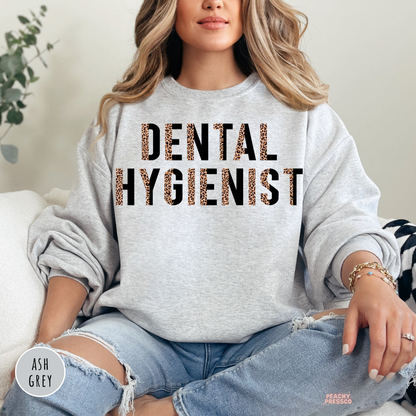 Ash grey crewneck sweatshirt with a modern leopard print Dental Hygienist graphic, a cozy gift for dental hygienists, dental clinics, and dentist office staff.