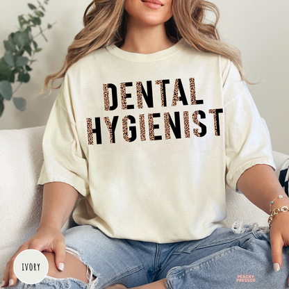 Ivory unisex t-shirt with a bold leopard print Dental Hygienist design, perfect for dental hygienists, dentist office staff, and dental professional gifts.