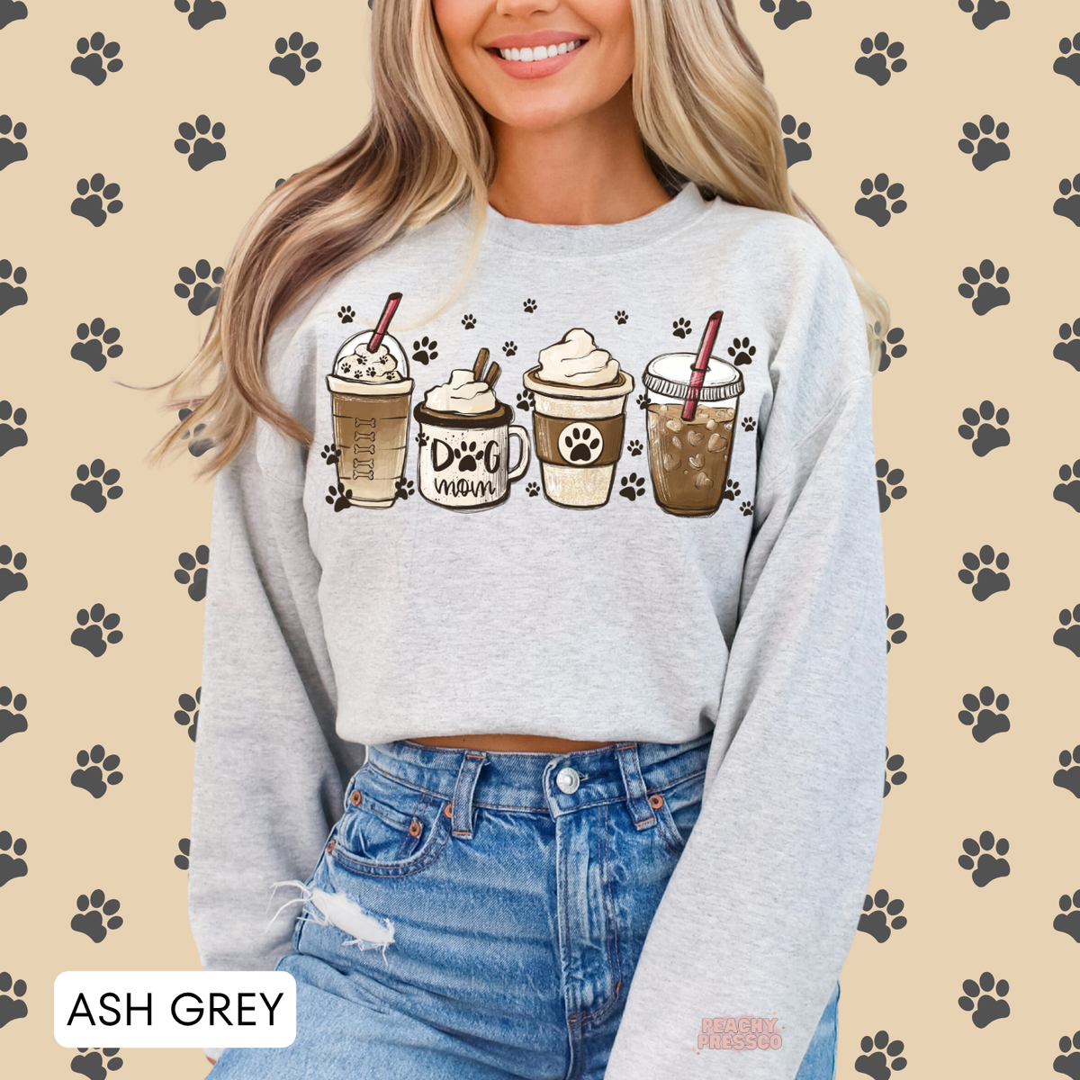 Ash grey Dog Mom coffee sweatshirt featuring four illustrated coffee cups, paw prints and a cute dog mom design.