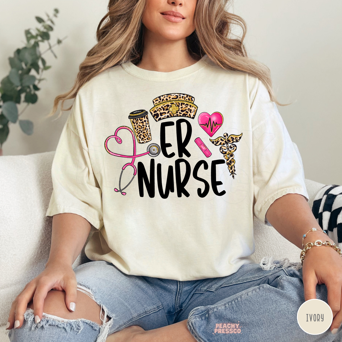 Ivory ER Nurse graphic T-shirt with leopard print nursing hat, pink heart stethoscope, coffee cup and emergency room nurse design.