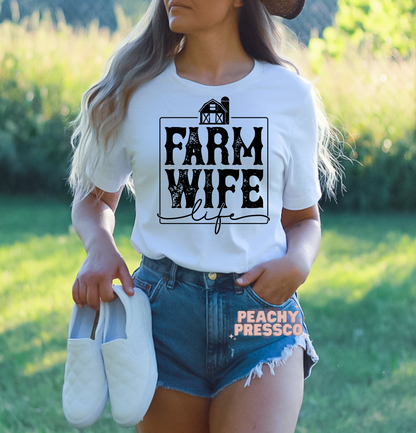 White Farm Wife Life graphic tee with distressed farmhouse design worn outdoors, perfect for country living and western style.