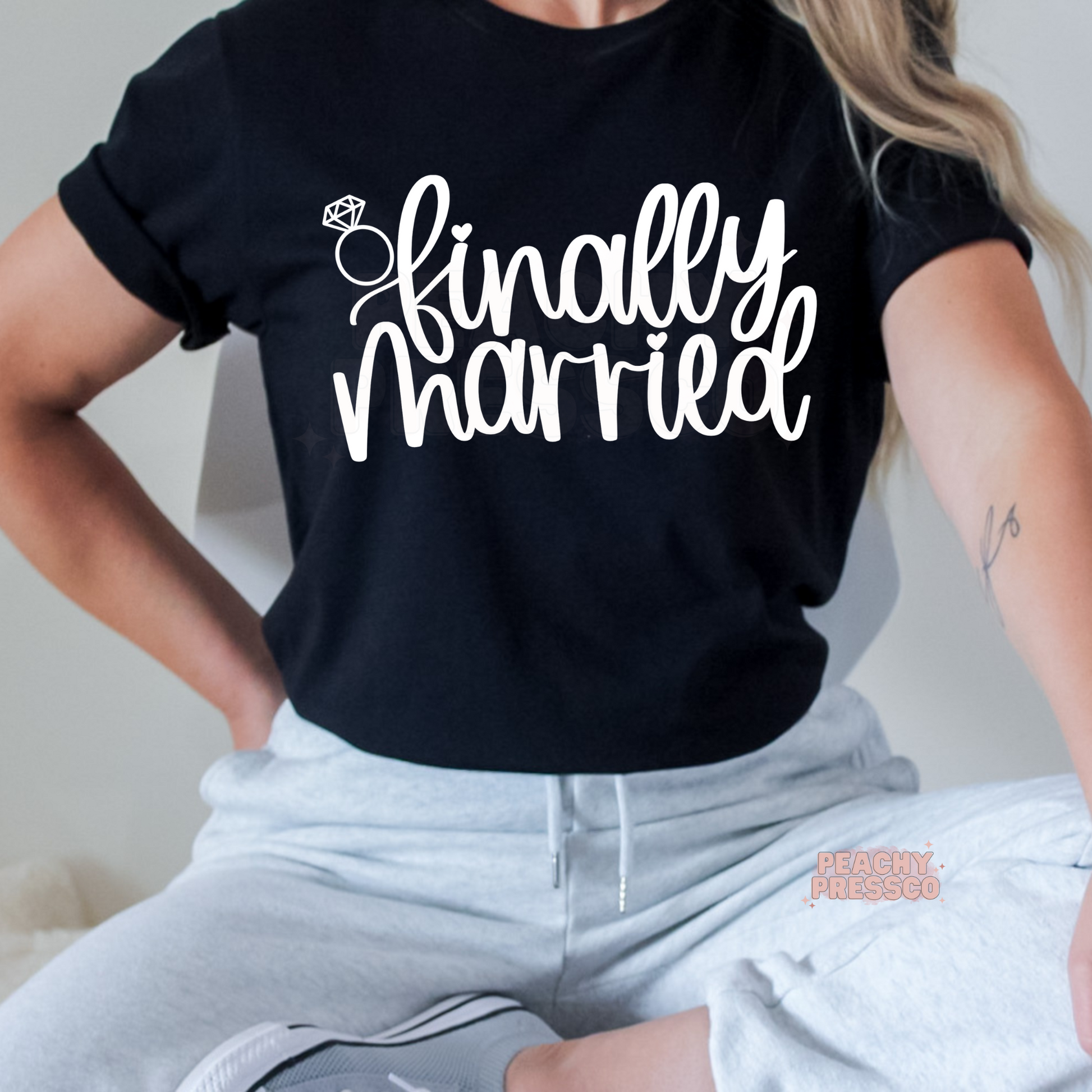 Black t-shirt with a white "Finally Married" design and diamond ring graphic, ideal for brides, newlyweds, honeymoon outfits, wedding celebrations, and matching couple apparel.
