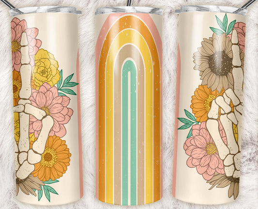 20 oz skinny tumbler featuring a skeleton hand peace sign surrounded by retro flowers and a vintage rainbow on a cream background. Includes clear lid and reusable straw.