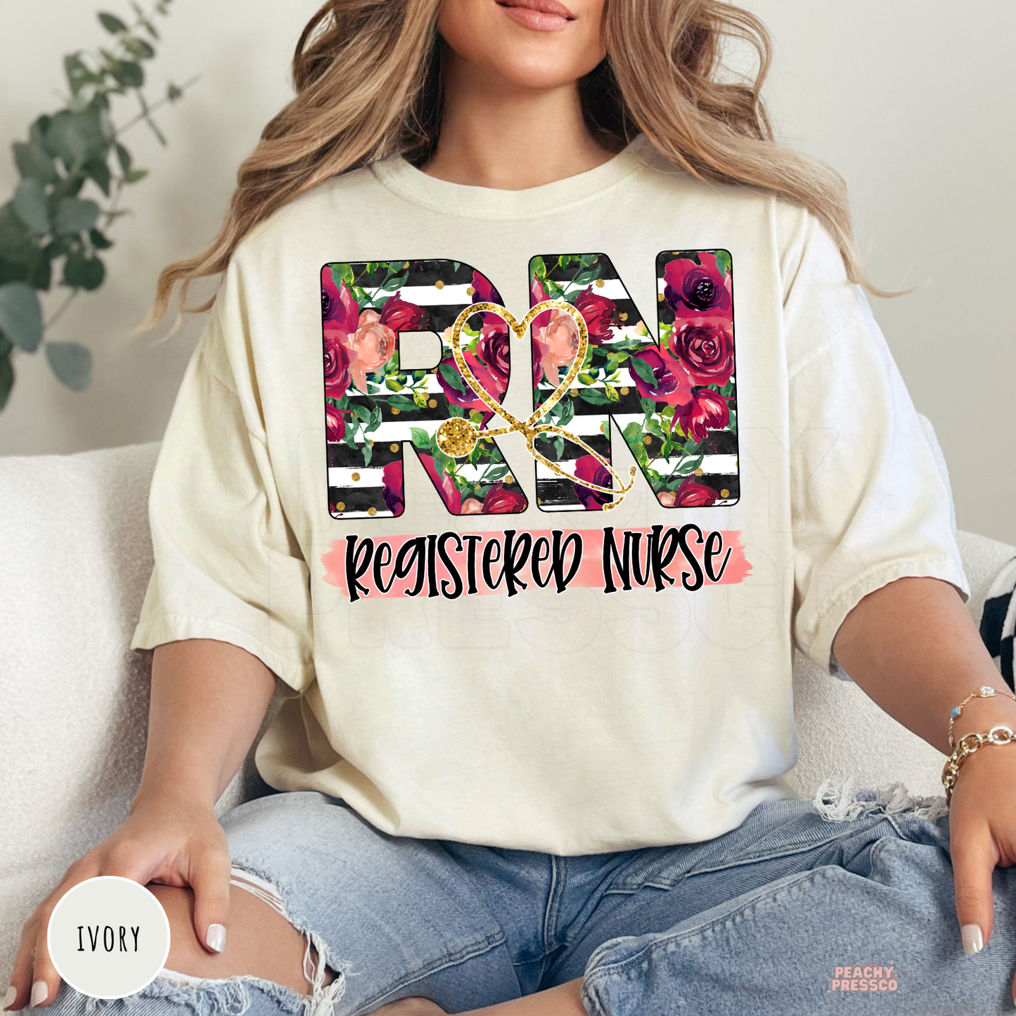 Ivory Comfort Colors t-shirt featuring a floral RN Registered Nurse graphic with burgundy flowers and a gold stethoscope.