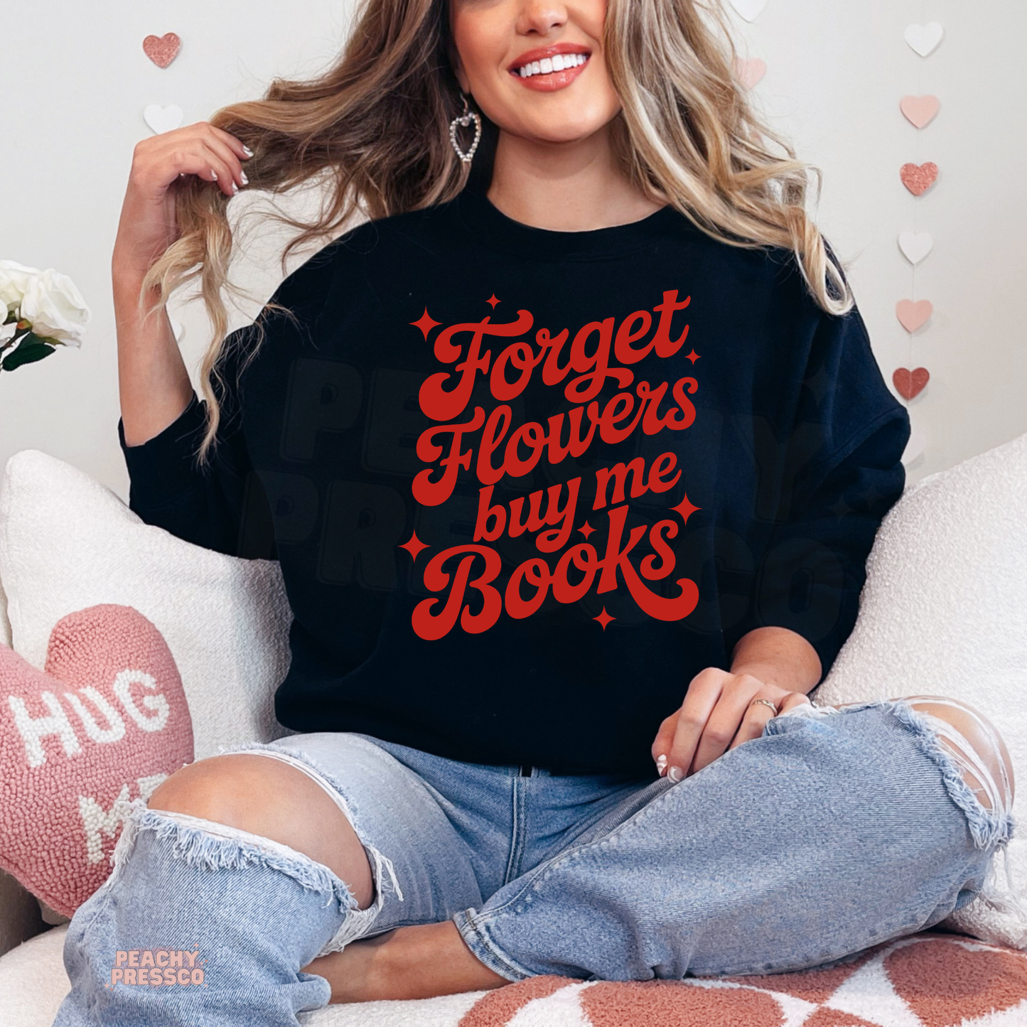 Black sweatshirt featuring the bold "Forget Flowers Buy Me Books" graphic in retro red lettering, perfect for book lovers.