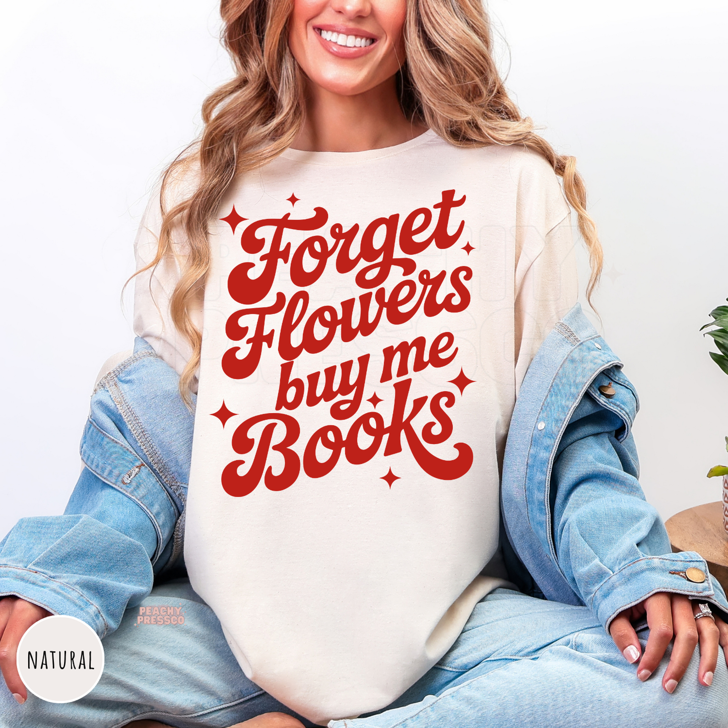 Natural shirt featuring the bold red quote "Forget Flowers Buy Me Books" in retro typography for book lovers and Valentine's Day.