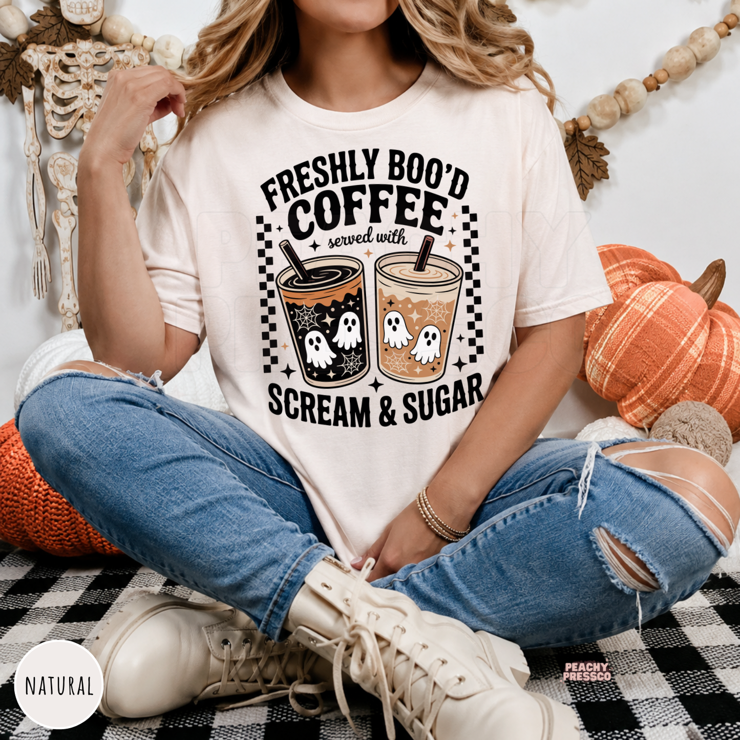 Woman wearing a natural Halloween t-shirt with a Freshly Boo'd Coffee Served with Scream & Sugar ghost coffee design for spooky season and coffee lovers.