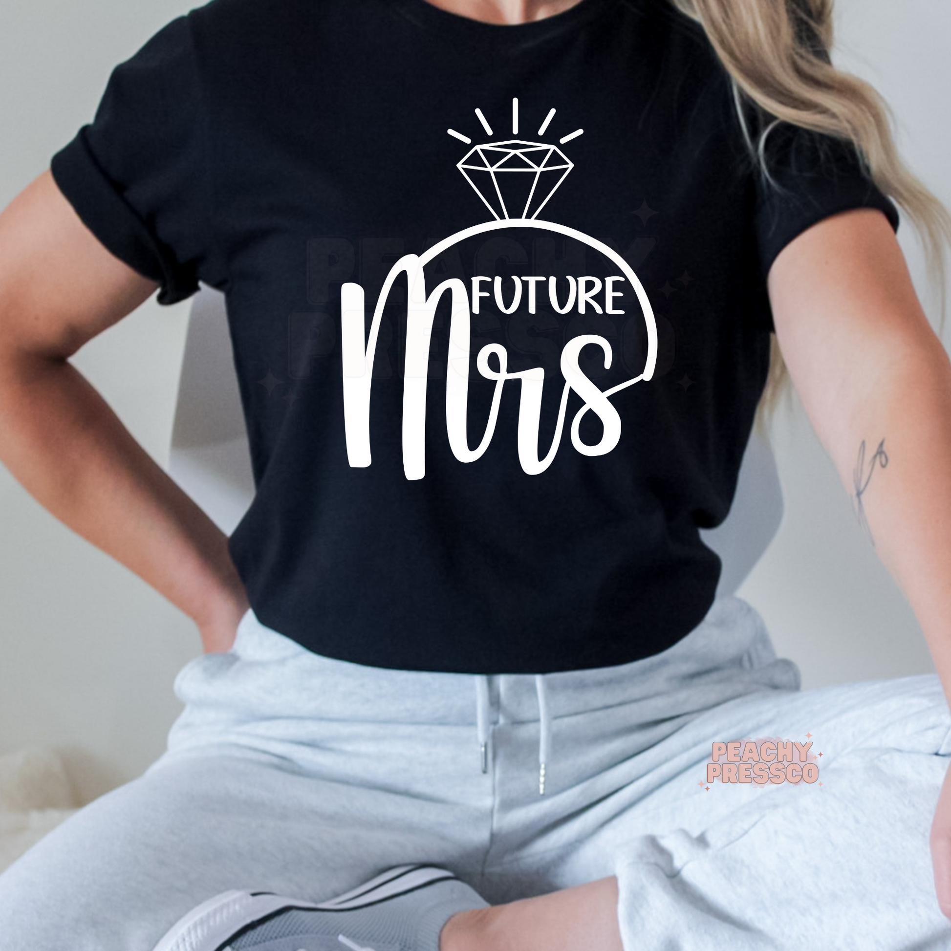 Black t-shirt displaying a bold white "Future Mrs" graphic with a sparkling diamond ring, perfect for engaged brides, bridal showers, bachelorette parties, engagement gifts, and wedding celebrations.