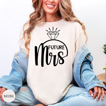 Natural shirt featuring a black "Future Mrs" design with a diamond ring illustration, a cozy choice for brides-to-be, bridal showers, engagement parties, and pre-wedding celebrations.