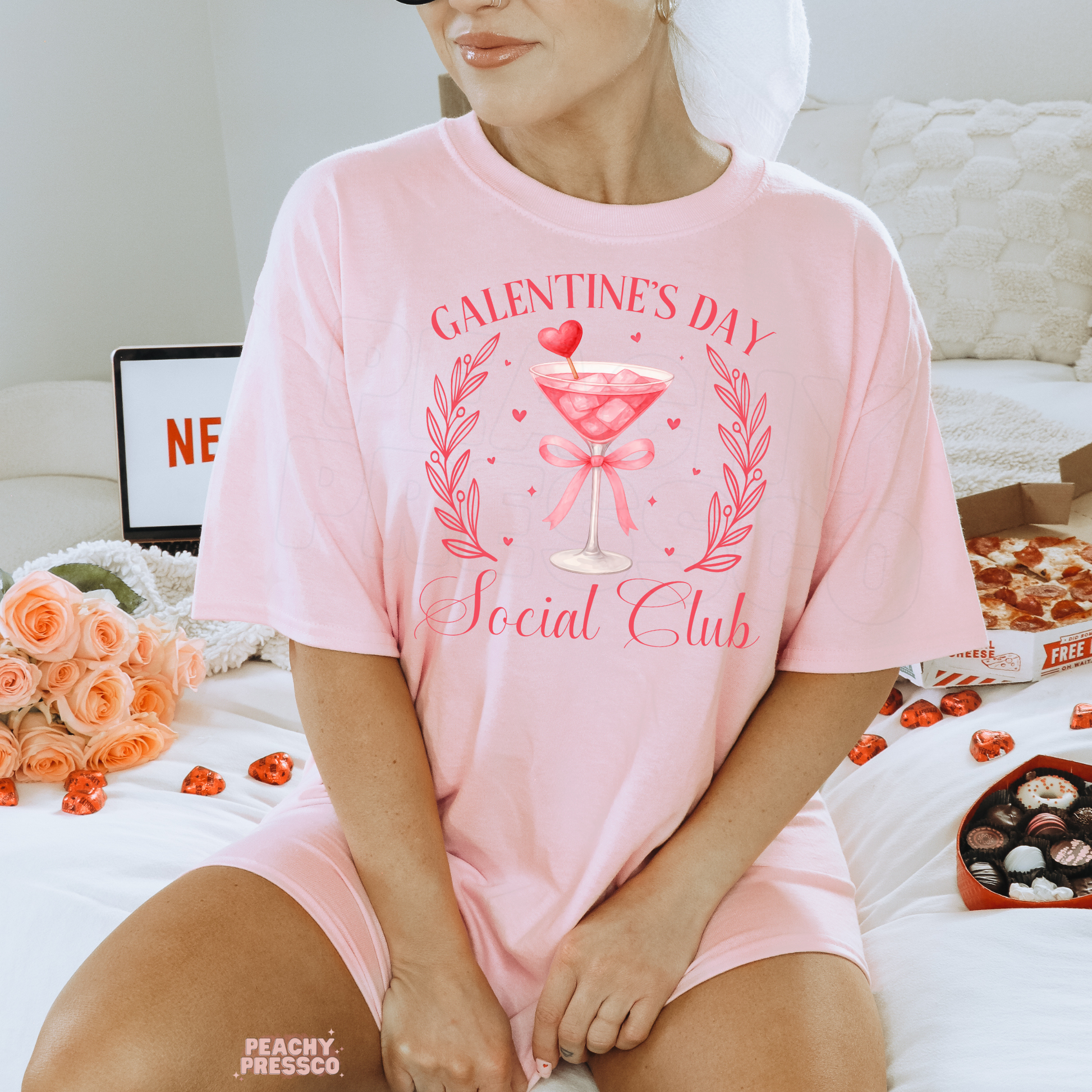 Light pink lounge shirt featuring a Galentine's Day Social Club cocktail graphic with a pink martini, ribbon bow, and fun girls' night Valentine's theme.