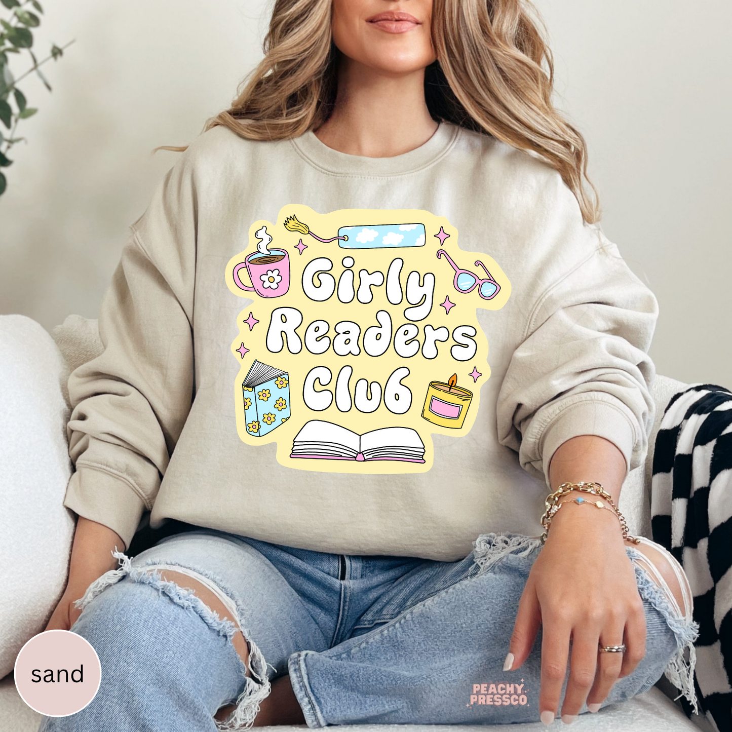 Sand crewneck sweatshirt featuring the Girly Readers Club graphic with pastel reading-themed artwork for book lovers.