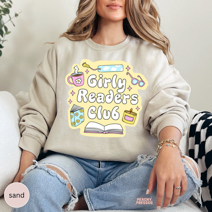 Sand crewneck sweatshirt featuring the Girly Readers Club graphic with pastel reading-themed artwork for book lovers.